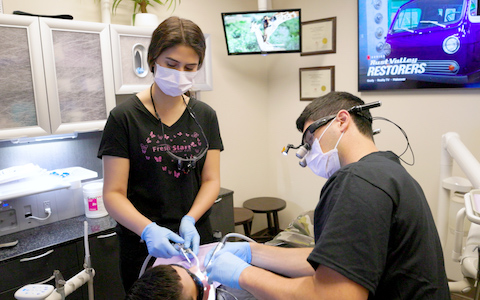 Dr. Steignberg and Dr. Etesse treating a patient with gum disease in Solana Beach, CA